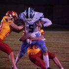 Southwest’s Deric Kelley runs through two Red Cloud defenders in the Roughriders 35-0 win over the Warriors in the Six-Man semifinals. (For Harvest Sports / Evan Jones, RPAC Rundown)